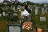 Mother kisses the grave of her son Zahoor Ahmed.jpg