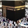 The believers clinging to the Ka'bah, as others perform tawaaf..jpg